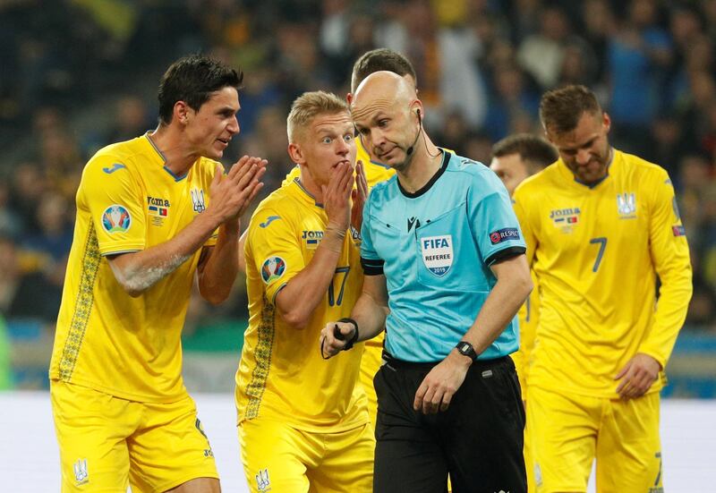 Soccer Football - Euro 2020 Qualifier - Group B - Ukraine v Portugal - NSC Olympiyskiy, Kiev, Ukraine - October 14, 2019 Ukraine's Roman Yaremchuk and Oleksandr Zinchenko remonstrate with referee Anthony Taylor after Ukraine's Taras Stepanenko is shown a red card REUTERS/Valentyn Ogirenko