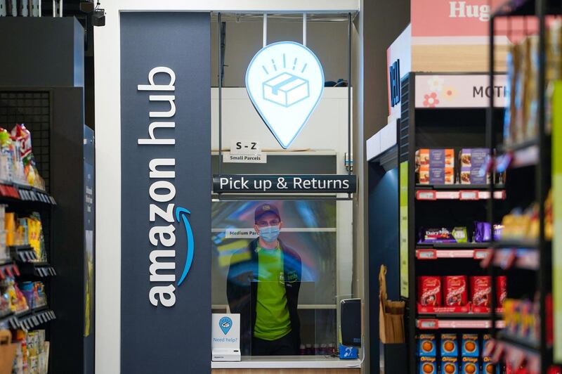 A worker stands at the Pick & Up and Returns point. AFP