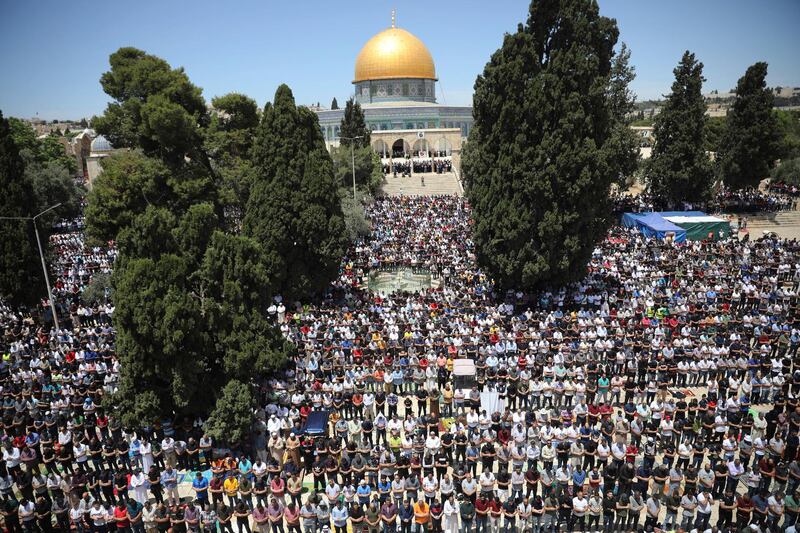 Worshippers take part in the last Friday prayers of Ramadan, outside the Dome of the Rock shrine. AP Photo