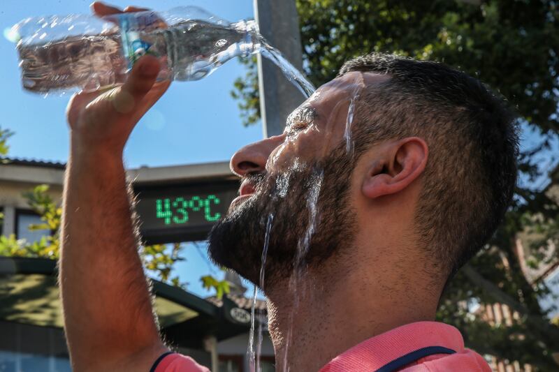 A man pours water on his head to cool off as the temperature hits 44°C in Turkey in August 2023. Getty Images