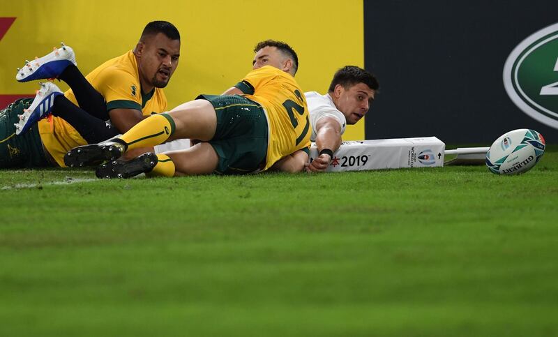 Australia's prop Taniela Tupou (L) and Australia's scrum-half Nic White (C) tackle England's scrum-half Ben Youngs during the Japan 2019 Rugby World Cup quarter-final match between England and Australia at the Oita Stadium in Oita. AFP