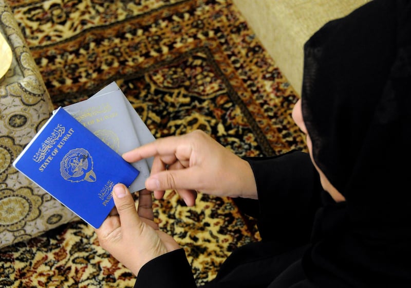The mother of a bidoon family shows the two kinds of Kuwait's passports in Sulaibiya, Kuwait on Wednesday, Jan. 28, 2009. The blue one is for a Kuwaiti citizen, the mother's, and the silver ones belong to her husband and children, all bidoons.

Credit: Gustavo Ferrari for The National