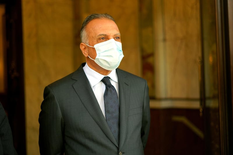 Iraqi Prime Minister Mustafa al-Kadhimi wears a protective face mask, following the outbreak of the coronavirus disease (COVID-19), as he stands at the prime minister's office in Baghdad, Iraq June 4, 2020.  Iraqi Prime Minister Media Office/Handout via REUTERS ATTENTION EDITORS - THIS IMAGE WAS PROVIDED BY A THIRD PARTY.