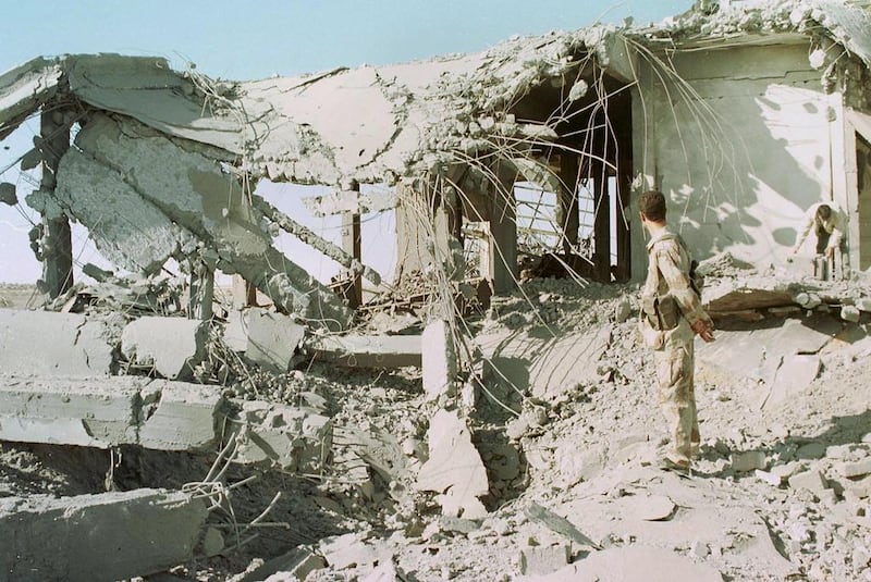 December 13, 2001: A Palestinian police officer inspects the rubble of a building at the Gaza international airport in Rafah after Israeli raids. Israeli warplanes bombarded Palestinian security buildings in the Gaza Strip and West Bank in swift revenge during the second intifida AFP Photo