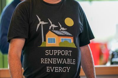 A man wears a shirt showing support for renewable energy during an event in Harrogate, England. Public support for net-zero strategies are growing. Getty