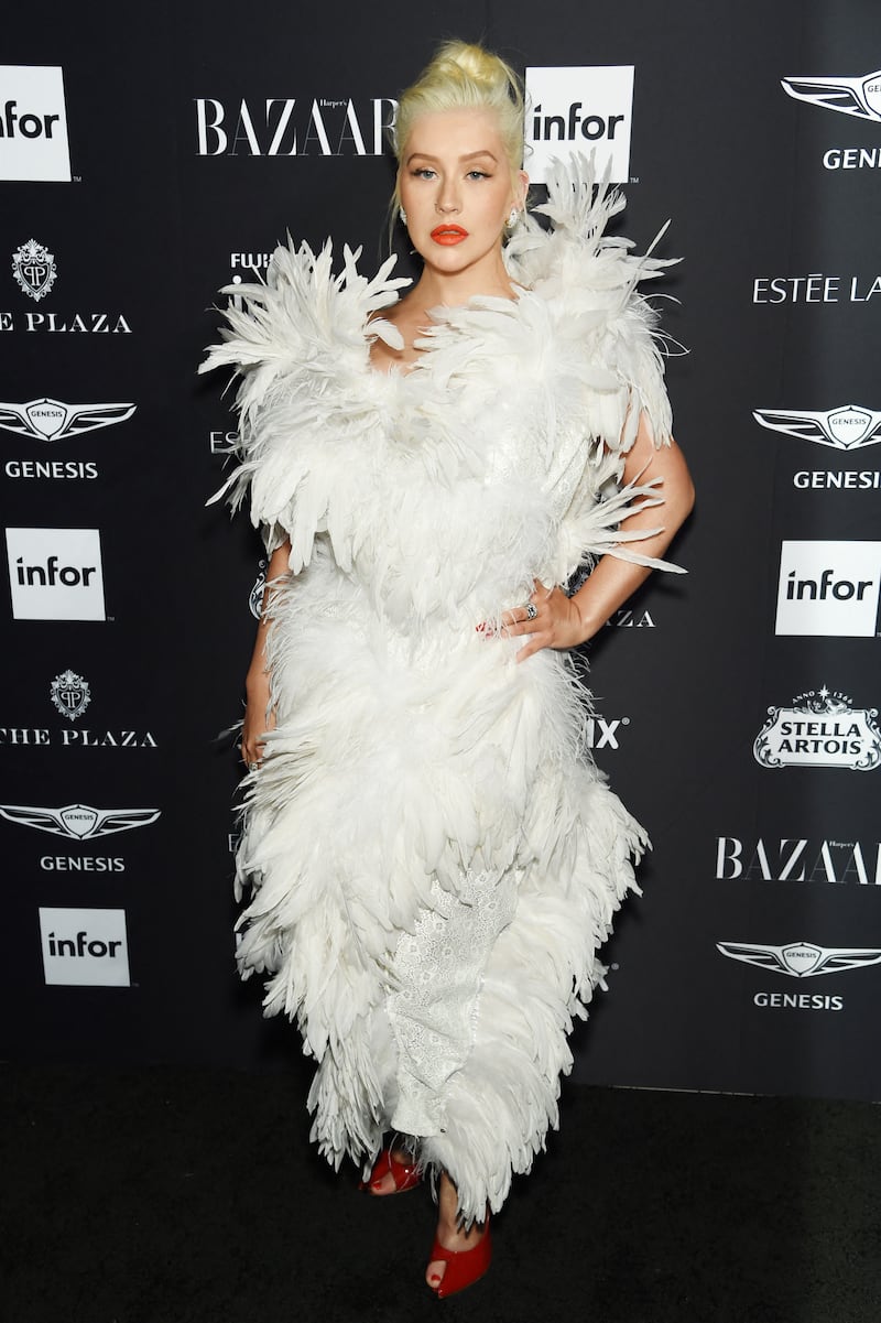 Christina Aguilera, wearing a white feathered dress, attends Harper's Bazaar's 'Icons By Carine Roitfeld' celebration on September 7, 2018 in New York City. AFP