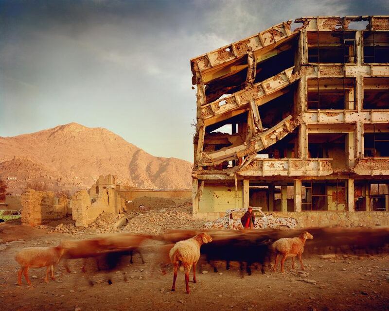 A bullet-scarred apartment building and shops in the Karte Char district of Kabul. Courtesy Simon Norfolk / Tate