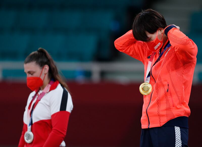 Gold medal winner Chizuru Arai of Japan, celebrates during the women's judo -70kg medal ceremony.