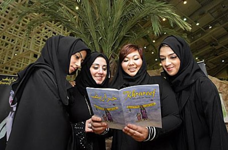From left, Atheer bin Shaker, Raisa al Zarouni, Sarah Ahrani and Abeer Abdul al Ali read from <i>Khrareef</i>.