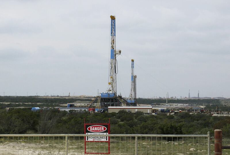Above, rigs contracted by Apache drill for crude oil locked tight in shale in West Texas. Terry Wade / Reuters