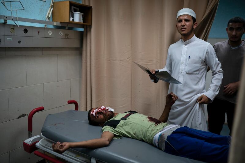 FILE - In this Friday, Sept. 14, 2018, file, photo, a Palestinian receives medical attention in a hospital after being injured during a protest at the Gaza Strip's border with Israel, east of Gaza City. A medical aid group says Thursday, Nov. 29, 2018 that the vast number of patients treated for gunshot wounds from months of violent border protests have overwhelmed Gazaâ€™s health care system. Doctors Without Borders says that thousands are in danger of infection and disability because Gaza hospitals cannot adequately treat them. (AP Photo/Felipe Dana, File)