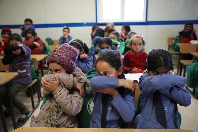 Syrian refugee students take part in a washing hands activity during an awareness campaign about coronavirus initiated by OXFAM and UNICEF at Zaatari refugee camp in the Jordanian city of Mafraq, near the border with Syria, March 11, 2020. REUTERS/Muhammad Hamed
