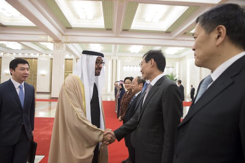 Sheikh Mohammed bin Zayed, Crown Prince of Abu Dhabi and Deputy Supreme Commander of the Armed Forces, greets a member of the Chinese delegation after being received by Li Yuanchao, Vice President of China (not shown), at the Great Hall of the People during a state visit to China. Mohamed Al Hammadi / Crown Prince Court - Abu Dhabi