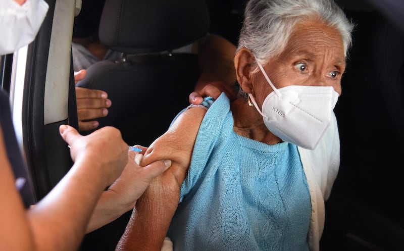 An elderly woman is inoculated with India's Covaxin vaccine at the public hospital in Villa Elisa, Paraguay. AFP