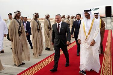 A handout picture released by the Jordanian Royal Palace on May 22, 2019 shows Jordanian King Abdullah II (C) being received by the UAE's Sheikh Mohamed bin Zayed Al-Nahyan (R), Crown Prince of Abu Dhabi Deputy Supreme Commander of the Armed Forces, upon the former's arrival at Abu Dhabi International Airport. (Photo by Yousef ALLAN / Jordanian Royal Palace / AFP) / RESTRICTED TO EDITORIAL USE - MANDATORY CREDIT "AFP PHOTO / JORDANIAN ROYAL PALACE / YOUSEF ALLAN" - NO MARKETING NO ADVERTISING CAMPAIGNS - DISTRIBUTED AS A SERVICE TO CLIENTS