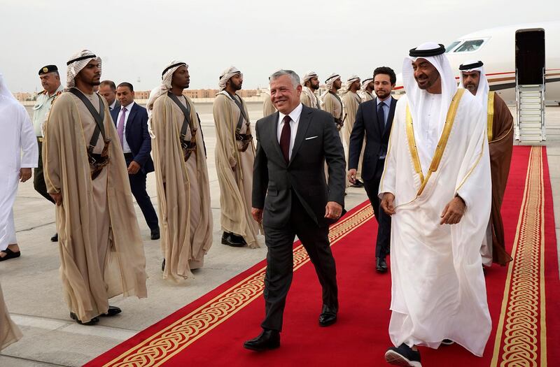 A handout picture released by the Jordanian Royal Palace on May 22, 2019 shows Jordanian King Abdullah II (C) being received by the UAE's Sheikh Mohamed bin Zayed Al-Nahyan (R), Crown Prince of Abu Dhabi Deputy Supreme Commander of the Armed Forces, upon the former's arrival at Abu Dhabi International Airport. (Photo by Yousef ALLAN / Jordanian Royal Palace / AFP) / RESTRICTED TO EDITORIAL USE - MANDATORY CREDIT "AFP PHOTO / JORDANIAN ROYAL PALACE / YOUSEF ALLAN" - NO MARKETING NO ADVERTISING CAMPAIGNS - DISTRIBUTED AS A SERVICE TO CLIENTS
