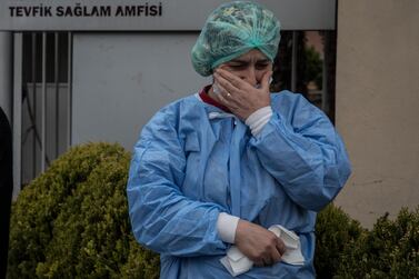 ISTANBUL, TURKEY - APRIL 02: Health care workers mourn outside the entrance of the Istanbul University Faculty of Medicine as they take part in a minutes silence at a memorial for Prof. Dr. Cemil Tascioglu who passed away overnight from the COVID-19 virus on April 02, 2020 in Istanbul, Turkey. Prof. Dr. Cemil Tascioglu was the first Turkish doctor to diagnose the coronavirus in Turkey and was well known throughout the medical community, Turkey's health Minister announced yesterday that 601 healthcare workers in Turkey have tested positive to the virus. Turkey has confirmed 168 deaths and 11,535 positive cases of the coronavirus, officials continue to implement steps to contain the spread of the virus including a ban on all intercity bus travel, all Internationals flights have been stopped and recreational activities such as fishing, jogging and barbecuing have been suspended in a bid to stop the spread of the virus. Getty