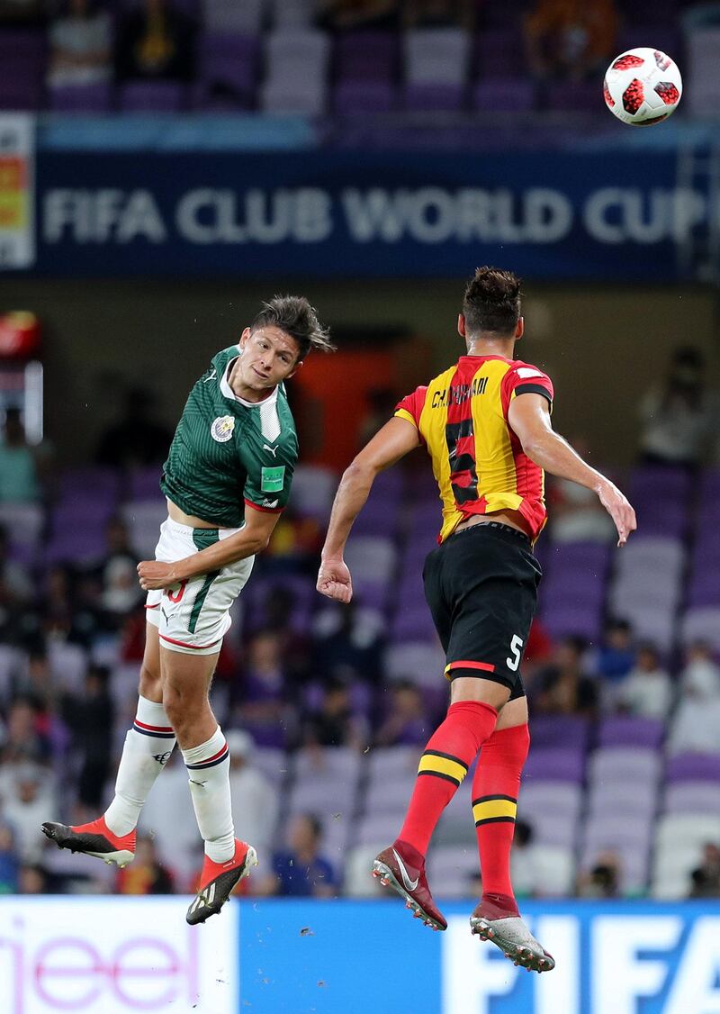 Al Ain, United Arab Emirates - December 18, 2018: Chamseddine Dhaouadi of Espérance and Jesus Godinez of Guadalajara compete during the game between Espérance de Tunis and Guadalajara in the Fifa Club World Cup. Tuesday the 18th of December 2018 at the Hazza Bin Zayed Stadium, Al Ain. Chris Whiteoak / The National