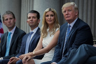 FILE - Donald Trump, right, sits with his children, from left, Eric Trump, Donald Trump Jr. , and Ivanka Trump during a groundbreaking ceremony for the Trump International Hotel on July 23, 2014, in Washington.  New York’s attorney general sued former President Donald Trump and his company on Wednesday, Sept.  21, 2022, alleging business fraud involving some of their most prized assets, including properties in Manhattan, Chicago and Washington, D. C.  (AP Photo / Evan Vucci, File)
