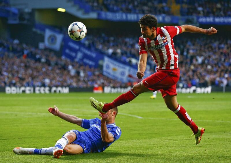 Atletico Madrid forward Diego Costa is blocked by Chelsea defender Gary Cahill during their Champions League semi-final match on Wednesday. Eddie Keogh / Reuters / April 30, 2014