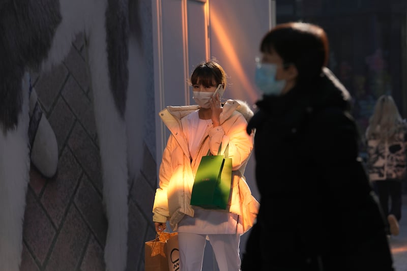 Visitors wear masks at a shopping centre in Beijing. Chinese state media said the first case of the Omicron variant had been detected in the country's mainland in Tianjin city, about 135km east of the capital. AP