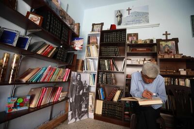 George Zaarour, a specialist in the Aramic language, reads a book written in the Aramic, at his shop in the Syrian mountain village of Maalula, in the Damascus region on May 13, 2019. Today, "80 percent of Maalula's inhabitants don't speak Aramaic, and the remaining 20 percent are over 60 years old," said an expert.
Etched out in the cliff face, and full of churches, convents, and monasteries, Maalula is considered a symbol of Christian presence in the Damascus region. 
 / AFP / LOUAI BESHARA
