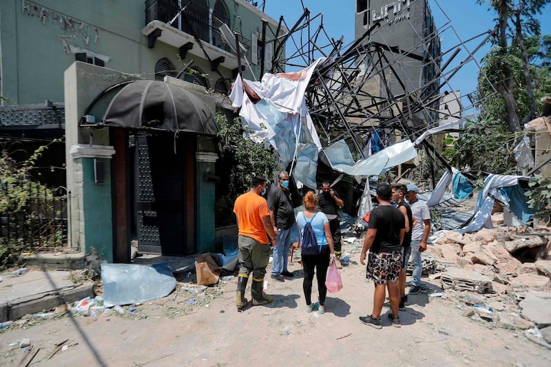 Lebanese inspect the damage in the aftermath of yesterday's blast that tore through Lebanon's capital.  AFP