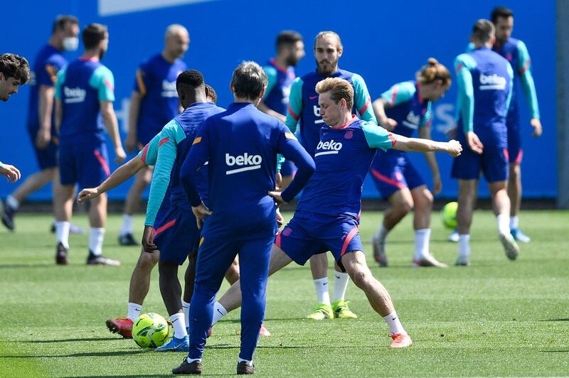 Barcelona midfielder Frenkie de Jong (R) takes part in a training session at the Joan Gamper Sports City. AFP