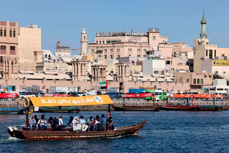 People ride an abra on the Creek between Deira and Bur Dubai. AFP