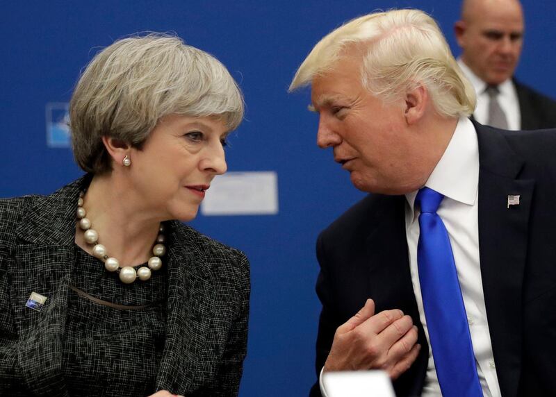 FILE- In this Thursday, May 25, 2017 file photo, U.S. President Donald Trump, right, speaks to British Prime Minister Theresa May during in a working dinner meeting at the NATO headquarters during a NATO summit of heads of state and government in Brussels. U.S. President Donald Trump's visit to Britain next week will take him to a palace, a country mansion and a castle _ and keep him away from noisy protests in London. Prime Minister Theresa May's office says Trump arrives Thursday, July 12, 2018 and will attend a dinner with business leaders at Blenheim Palace, Winston Churchillâ€™s birthplace. (AP Photo/Matt Dunham, Pool, File)