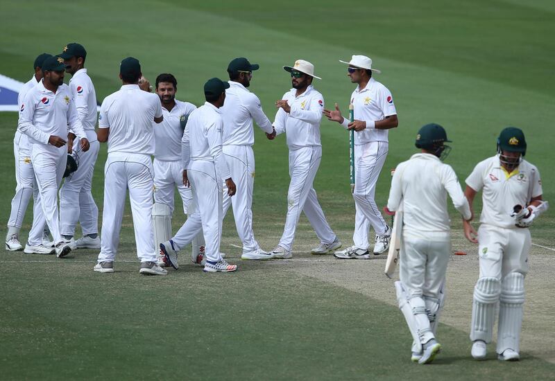 Pakistan's players celebrate after they beat Australia in their test match in Abu Dhabi, United Arab Emirates, Friday, Oct. 19, 2018. (AP Photo/Kamran Jebreili)