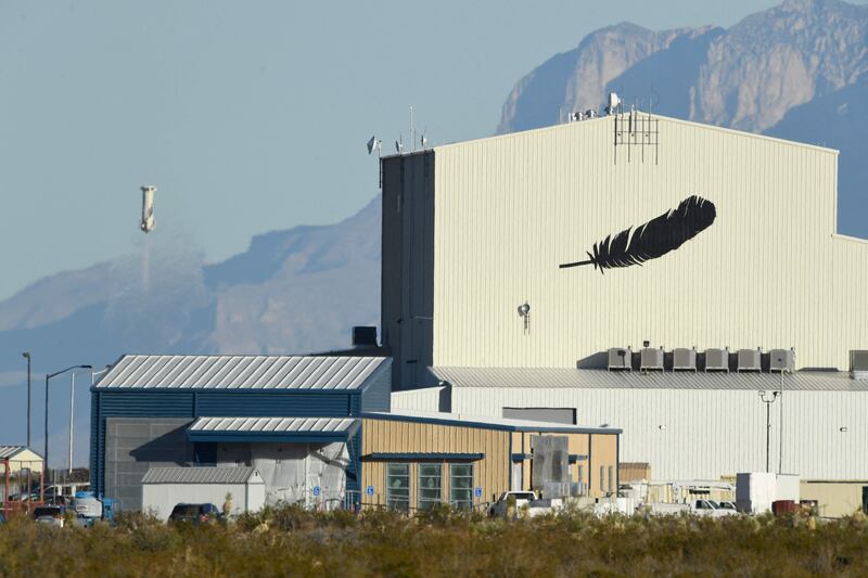 A Blue Origin New Shepard rocket returns to Earth at the company's West Texas headquarters near Van Horn. The Guadalupe Mountain Range can be seen in the foreground. AFP