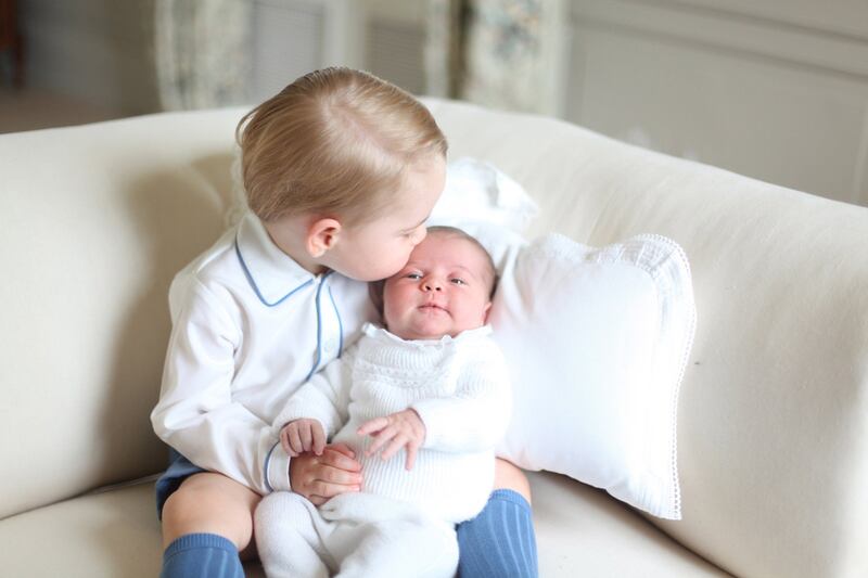 Prince George kisses his little sister Princess Charlotte at Anmer Hall in Norfolk on June 6, 2015. Duchess of Cambridge / Reuters