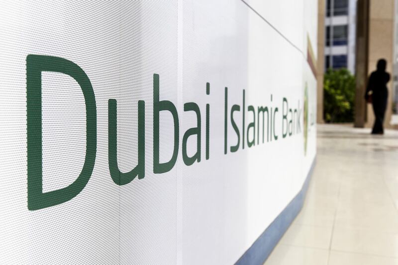 A pedestrian passes signage advertising the Dubai Islamic Bank PJSC bank in Dubai, United Arab Emirates, on Tuesday, Sept. 4, 2018. Abu Dhabi is engineering a second bank merger in its latest attempt to stay competitive in the era of lower oil prices. Photographer: Christopher Pike/Bloomberg