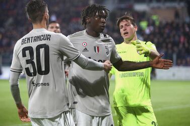 Moise Kean, centre, reacts to Cagliari fans after scoring for Juventus. He had been the victim of racist chanting throughout the game. Getty 