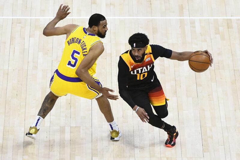 SALT LAKE CITY, UTAH - FEBRUARY 24: Mike Conley #10 of the Utah Jazz drives past Talen Horton-Tucker #5 of the Los Angeles Lakers during a game at Vivint Smart Home Arena on February 24, 2021 in Salt Lake City, Utah. NOTE TO USER: User expressly acknowledges and agrees that, by downloading and/or using this photograph, user is consenting to the terms and conditions of the Getty Images License Agreement.   Alex Goodlett/Getty Images/AFP
== FOR NEWSPAPERS, INTERNET, TELCOS & TELEVISION USE ONLY ==

