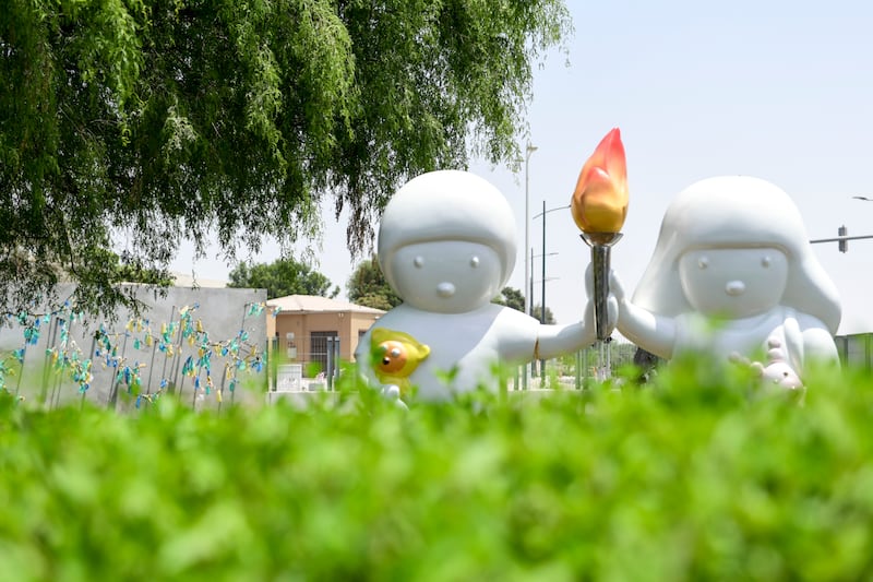 Noh Juno's sculpture features two figures holding the 'Flame of Hope' at the permanent exhibition Special Olympics Gardens outside Manarat Al Saadiyat, Abu Dhabi. Khushnum Bhandari / The National