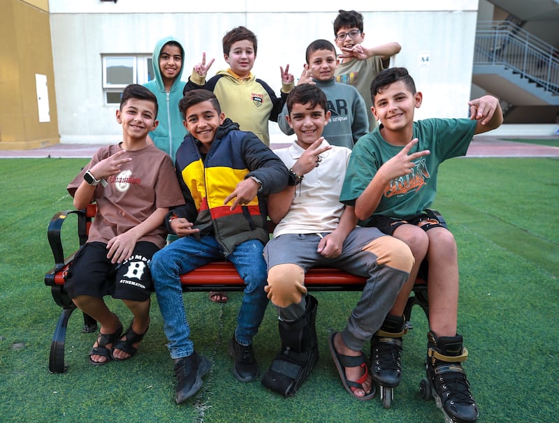 Yazan with fellow Palestinian children at the vast compound, which is currently home to more than 1,200 Gazan war survivors

