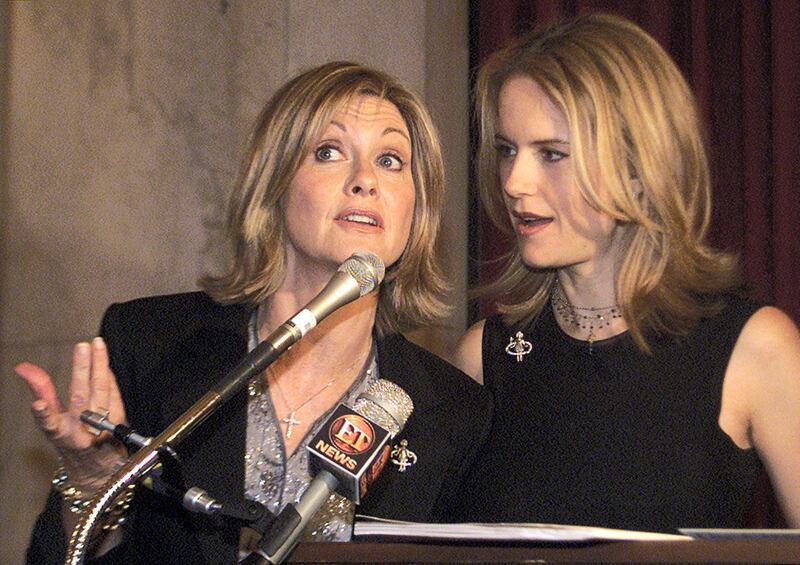 Actress/singer Olivia Newton-John (L) and actress Kelly Preston talk about their new video for the Children's Health Environmental Coalition (CHEC) on Capitol Hill in Washington May 9, 2001. The video promotes awareness of childproofing homes from dangerous environmental toxins.

BM/BK