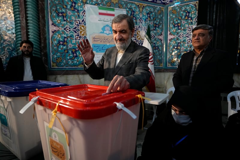Former Islamic Revolutionary Guard Corps commander Mohsen Rezaei casts his ballot at a polling station in Tehran. AP