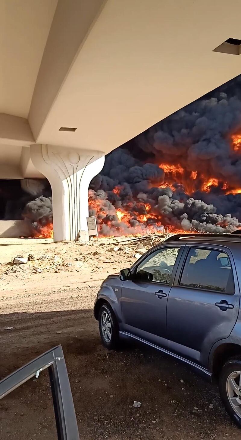 A fire is seen from under a bridge at the Cairo-Ismailia road, near Cairo, Egypt in this screengrab obtained from a social media video. REUTERS