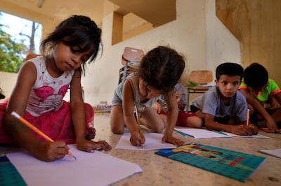 Children displaced from south Lebanon paint at a school being used as a shelter in the southern port city of Tyre, Lebanon, October 20, 2023. AP Photo