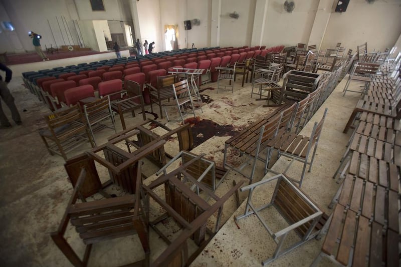 Chairs are upturned and blood stains the floor at the Army Public School auditorium the day after Taliban gunmen stormed the school in Peshawar on December 17, 2014. BK Bangash / AP Photo