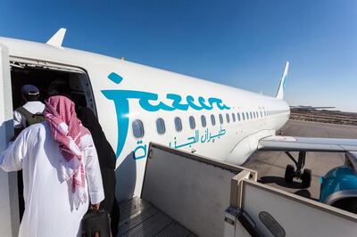 EJ56X4 Jazeera Airways airplane boarding at the Kuwait International Airport