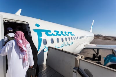 EJ56X4 Jazeera Airways airplane boarding at the Kuwait International Airport