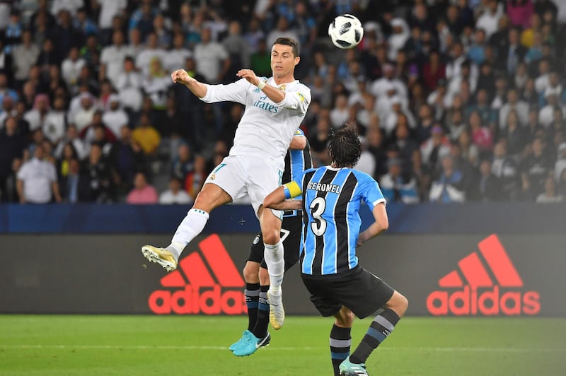Real Madrid's Cristiano Ronaldo vies for a header with Gremio's Pedro Geromel and Ramiro. Karim Sahib / AFP