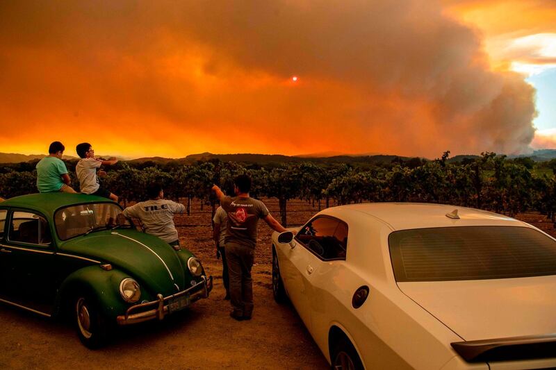 People watch the Walbridge fire in Healdsburg, California. AFP