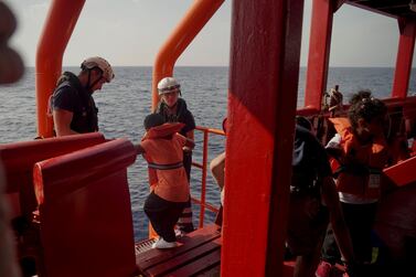 SOS Mediterranee crew help children disembark from the Ocean Viking into Maltese rescue ships in the Mediterranean Sea on Friday. AP