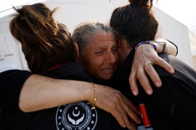 Leyla Ogural, 52, says goodbye to mental health workers Busra Isik and Ayse Tugcedemir in Antakya, Turkey, on March 3. Reuters
