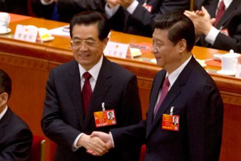 China's newly-elected President Xi Jinping shake hands with China's former President Hu Jintao during the fourth plenary meeting of the National People's Congress. Reuters / Jason Lee